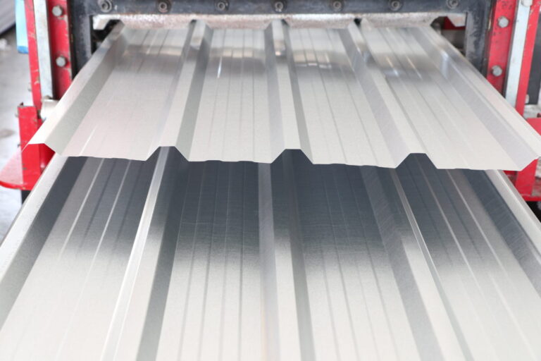 zinc coated metal sheet roof rolled from rolling machine made from coiled steel ; industry equipment background